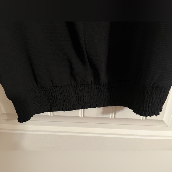 Ricki’s black blouse with arm cutouts. - Picture 2 of 4